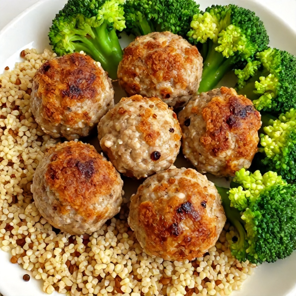 Plated Turkey Meatballs Meal Prep with quinoa, steamed broccoli, and a lemon wedge