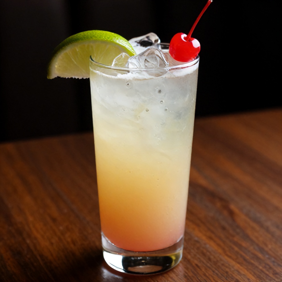 Glass of Refreshing Cherry Limeade with a lime wedge and cherry garnish