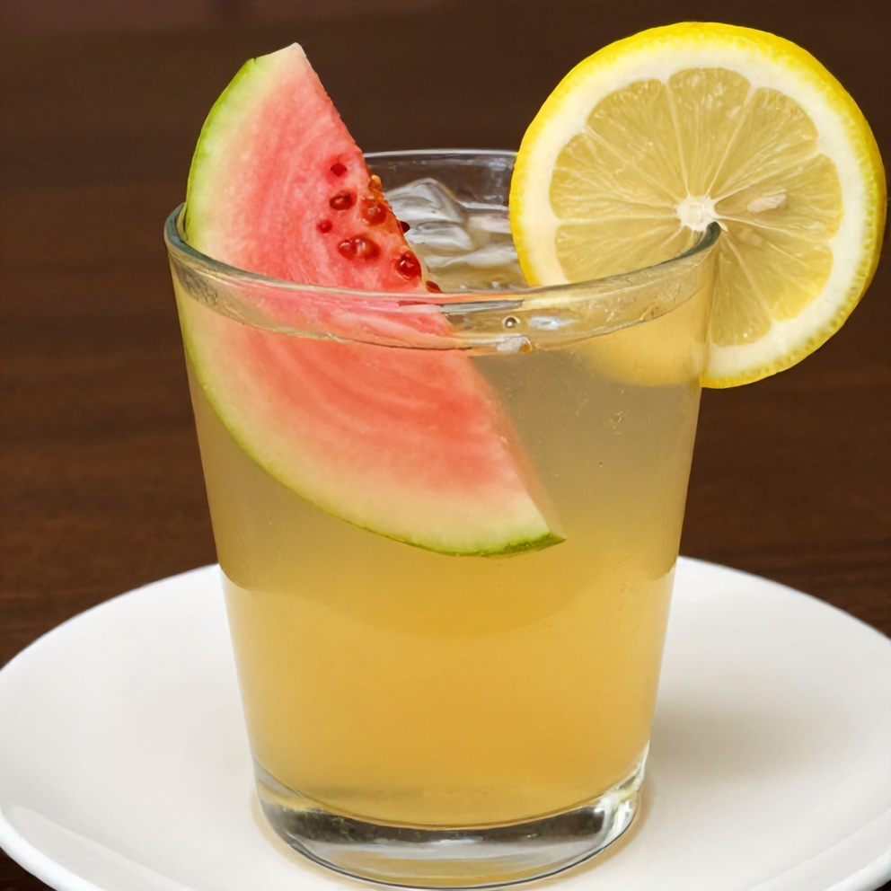 Glass of Guava White Tea Lemonade with a slice of guava and a lemon wheel