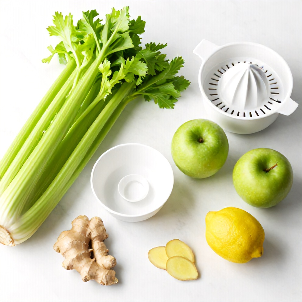 Celery, apples, lemon, ginger, and other ingredients laid out