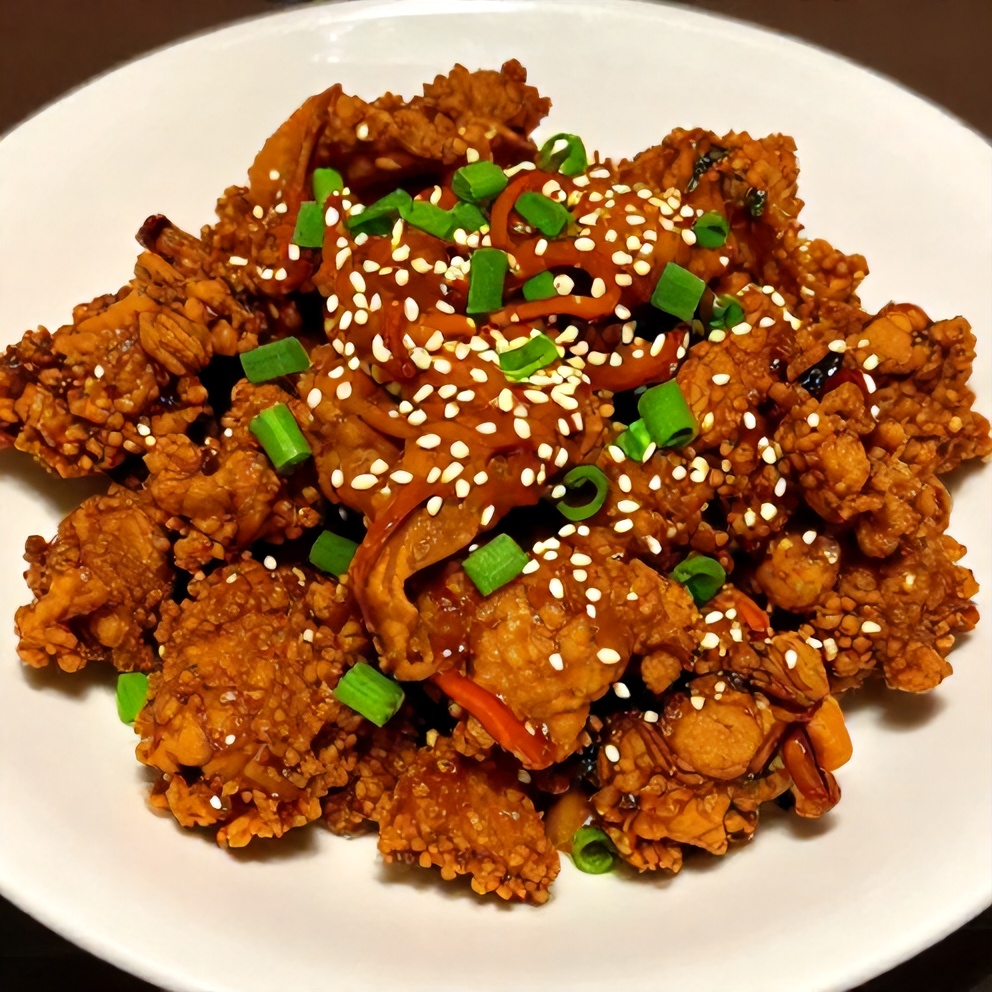 Plated crispy ground chicken stir-fry with spicy sauce