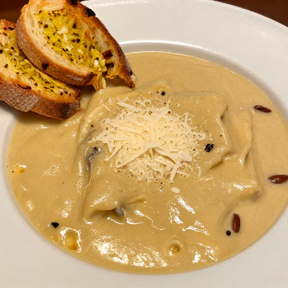 Bowl of White Lasagna Soup with garlic bread and parmesan cheese
